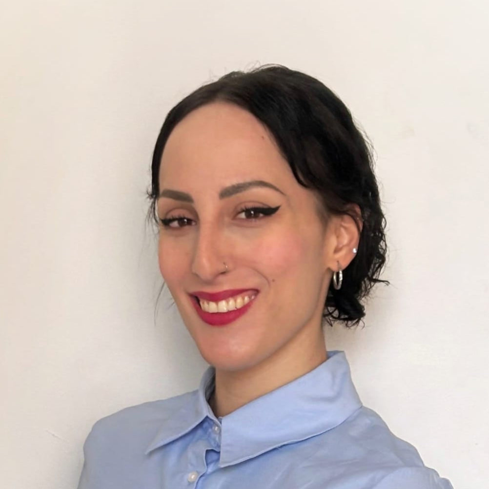 Elena Zizza, Swish & Click’s graphic designer, smiling against a white background — the artistic talent behind the company’s logo, visual identity, and standout creative projects.