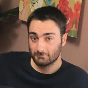 Jenson Price, creative and media director at Swish & Click, seated indoors with a confident expression — the imaginative mind behind the company’s branded storytelling and visual campaigns.